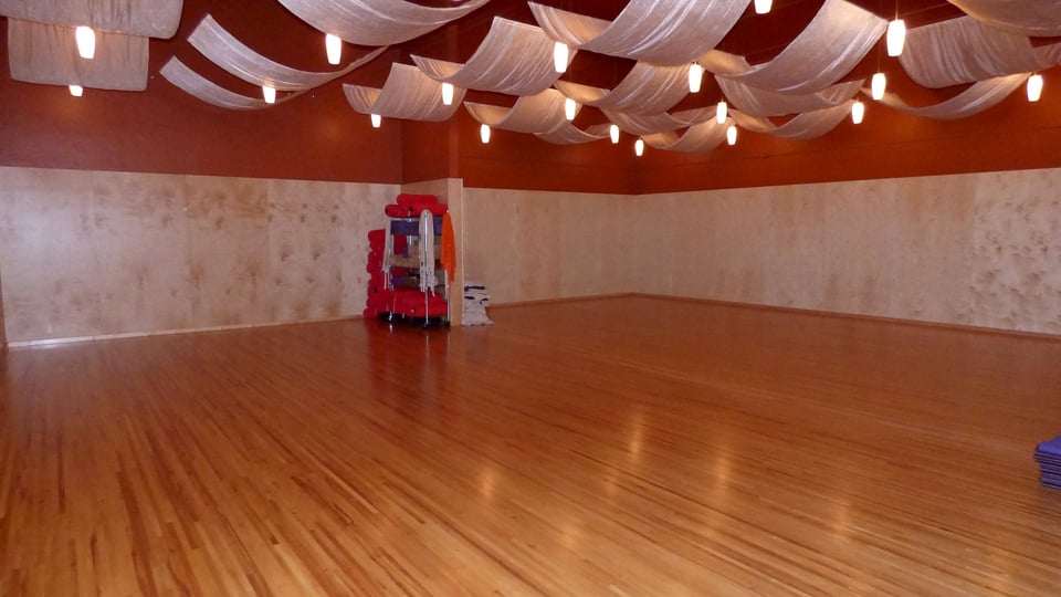 Commercial hardwood flooring installation in a large open room
