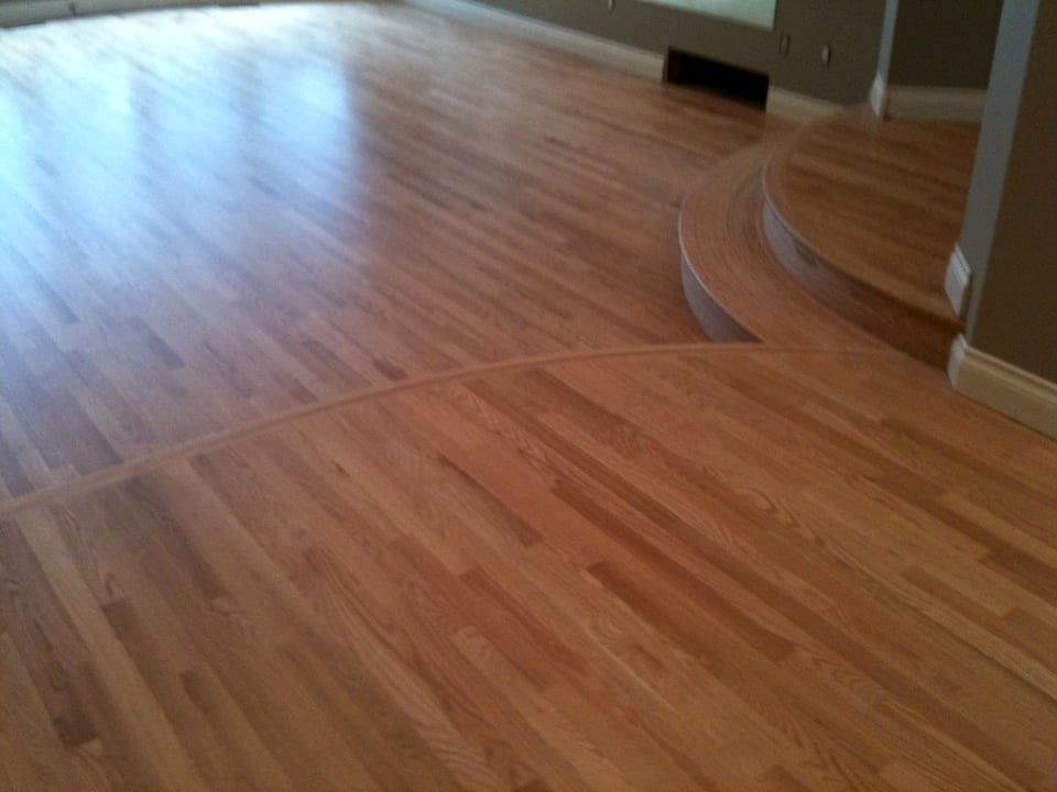 Wide-plank hardwood floor running the length of a living room