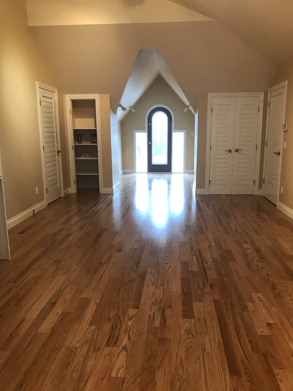 Herringbone pattern hardwood flooring laid in a residential space